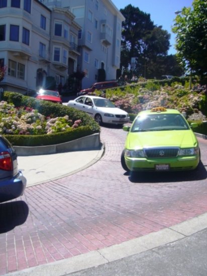 Someone taking a cab down Lombard Street