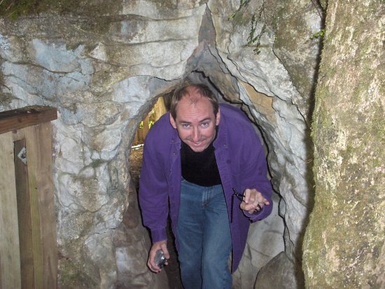 Colin emerging through a cave entrance