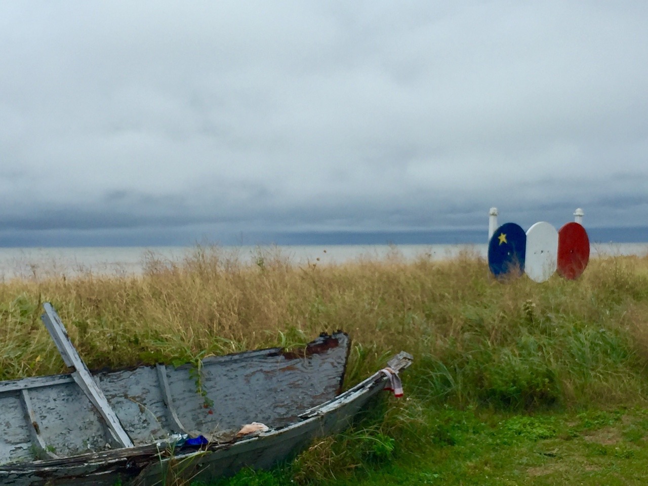 Broken Boat beside Acadian Flag